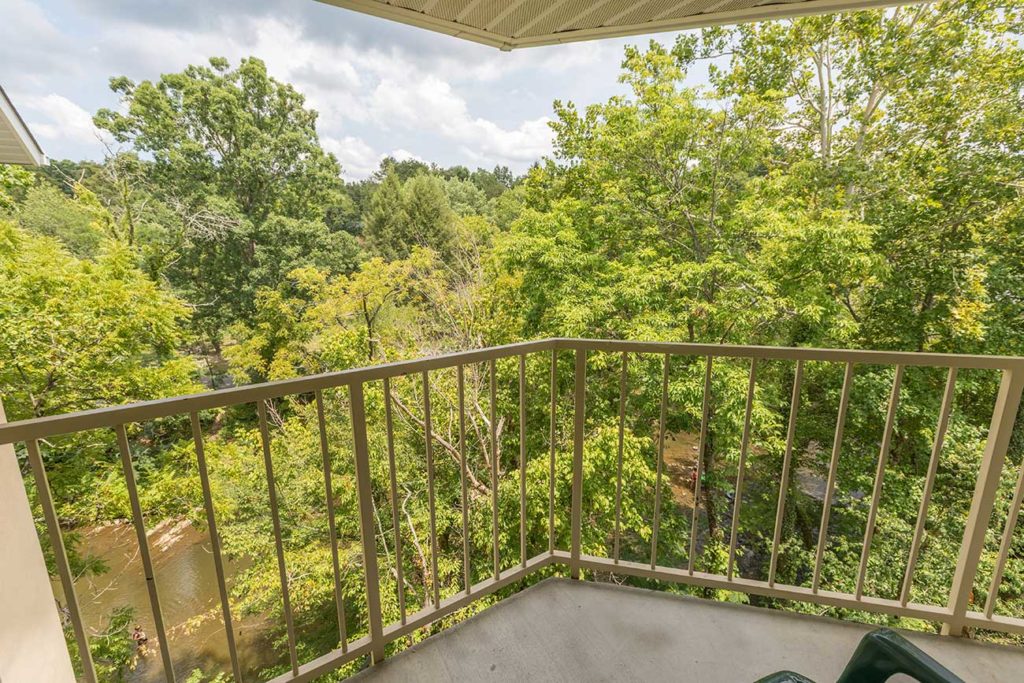 Hotel balcony with view of trees and river